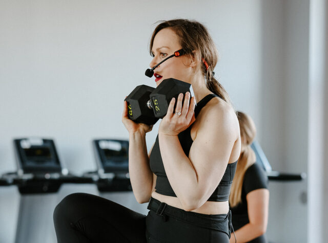Fitness instructor lifting weights